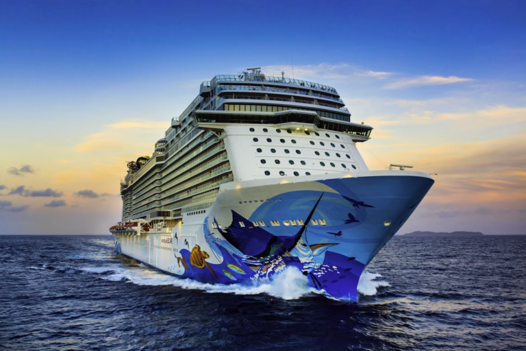 Norwegian Cruise Line's Norwegian Escape ship sailing in open water at sunset